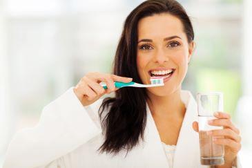 gum disease treatment rutland | woman brushing teeth